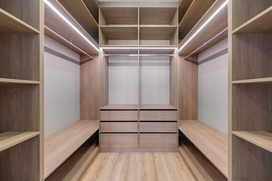 Beautifully organized walk-in closet with custom shelving and lighting