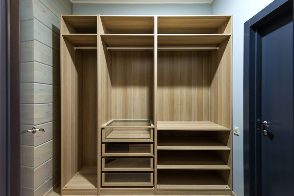 Efficient reach-in closet with wooden drawers and double hanging rods