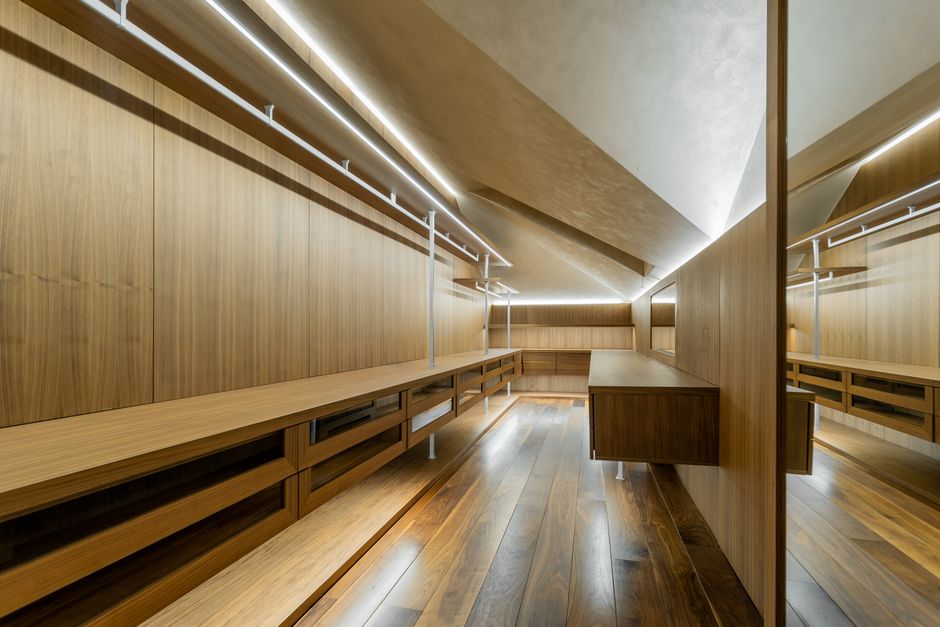 Luxury custom closet interior with wooden shelving and soft lighting